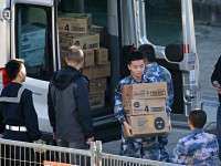 Military personnel unload boxes of baby formula and face masks on Thursday. Photographer: Adam Yip