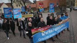 Protestors with a banner reading: ‘Stop Merkel! Secure borders, drop the CDU!’. Picture: Sean Gallup
